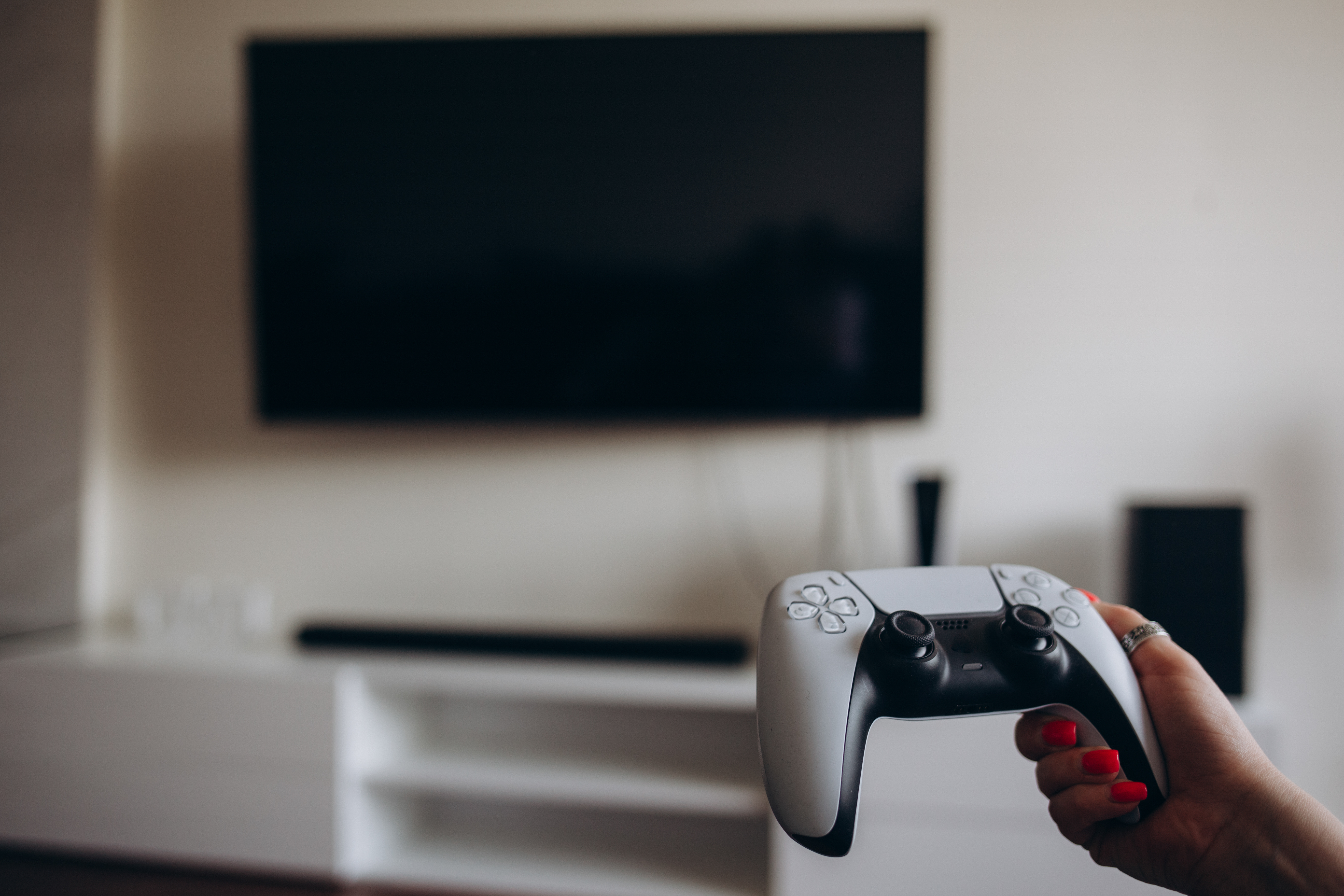 A young woman is playing a game console. Girl gamer and computer video games.